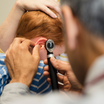 Physician Examining A Child's Ear