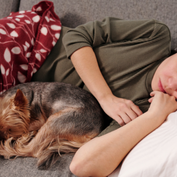 Woman sleeping with her dog