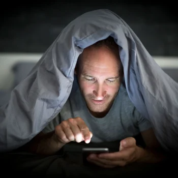 Man Playing on Phone Late at Night